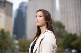 a woman in an MBA program stands in front of buildings in Chicago