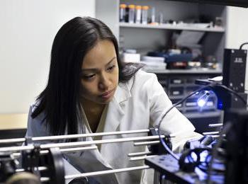 A student prepares a lymph node for laser analysis