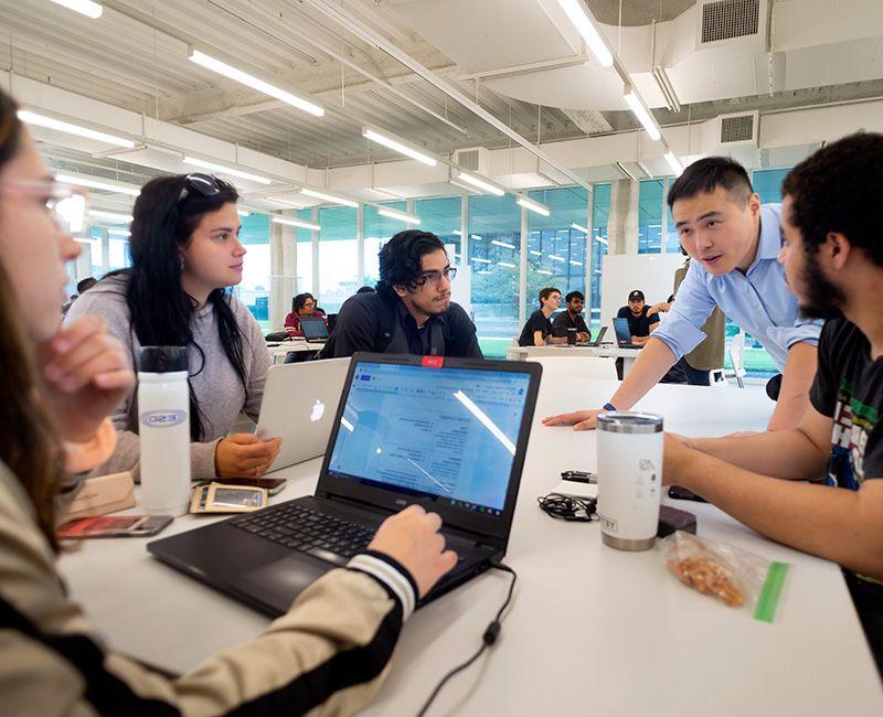 Students discuss an IPRO at a table in Kaplan Institute